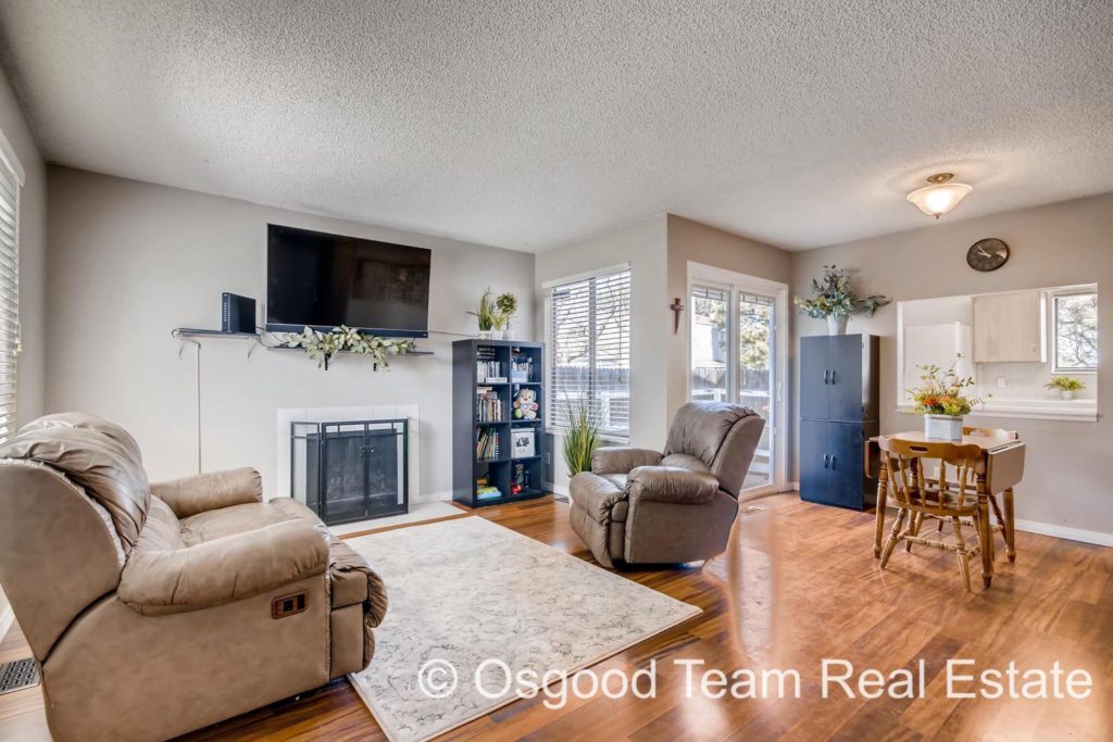 This well lit living room has beautiful natural light and is situated for easy access to the kitchen.