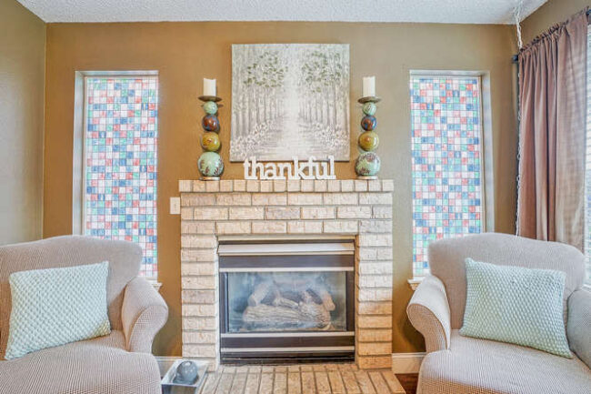 brick fireplace with side stain glass windows