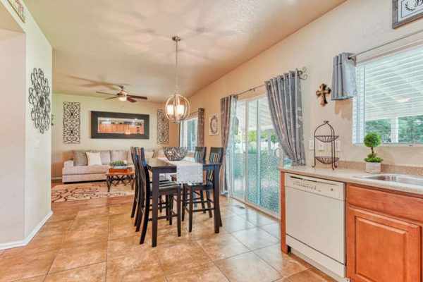 Open kitchen to family room with dining area and pendant light