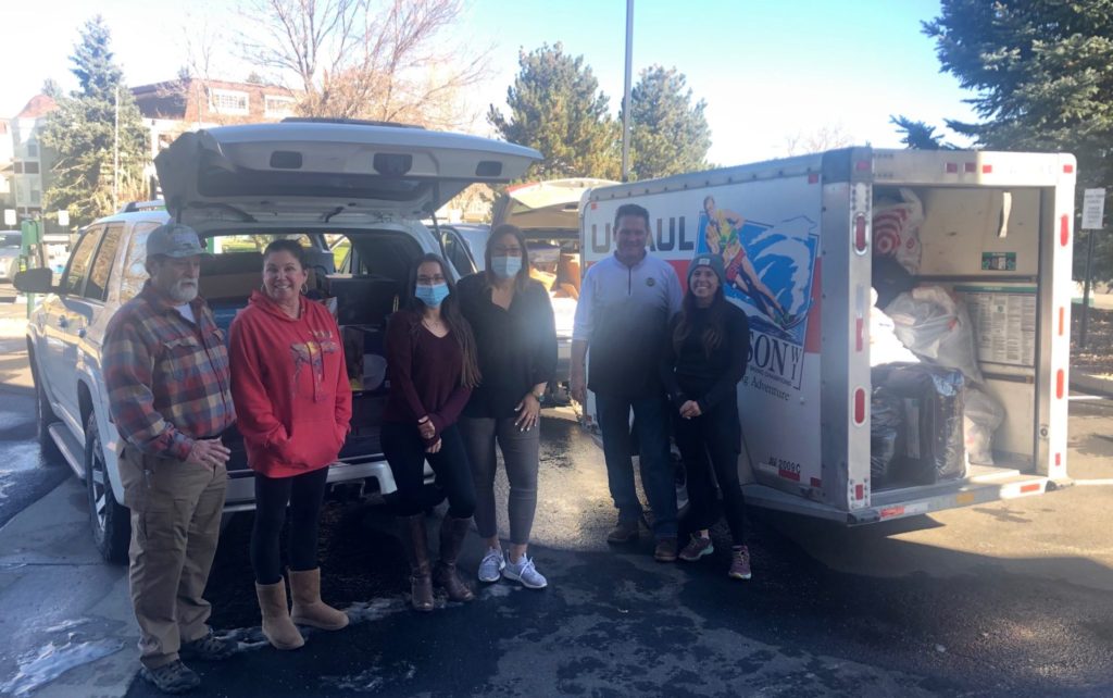 volunteers in front of uhaul trucks