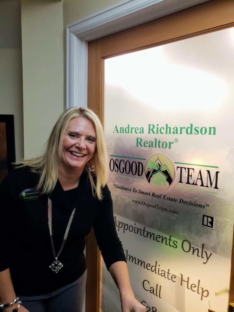 Award winning real estate agent Andrea Richardson standing in front of her office door in Elizabeth Colorado