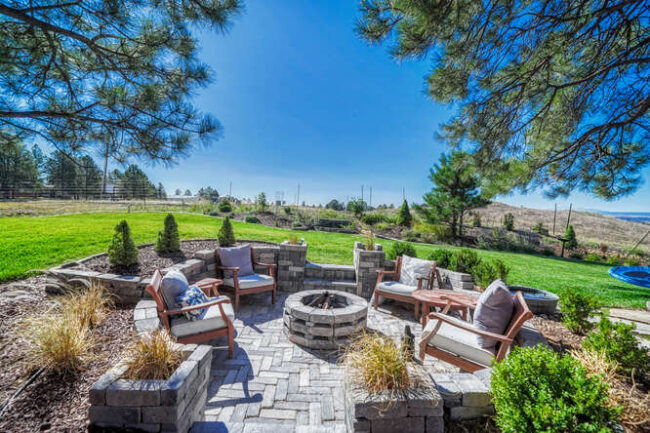 patio with stone pavers and fire pit with rocky mountain views in south denver colorado