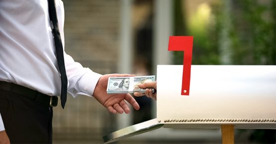 Mailbox man getting cash out of a mailbox