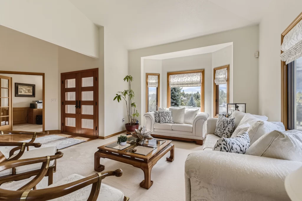 formal living room with bay window and custom 8 panel front door