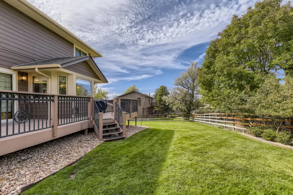 large backyard with low maintenance decking and custom metal railings