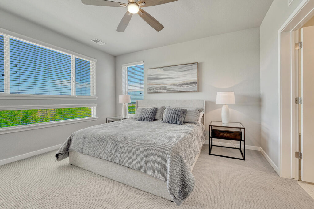 large bedroom with mountain views neutral paint