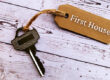 house key with 'first house' tag attached on white boards