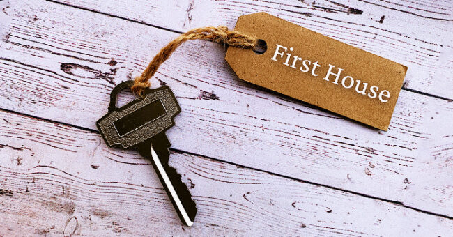 house key with 'first house' tag attached on white boards