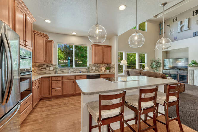 center island with seating and updraft cooktop