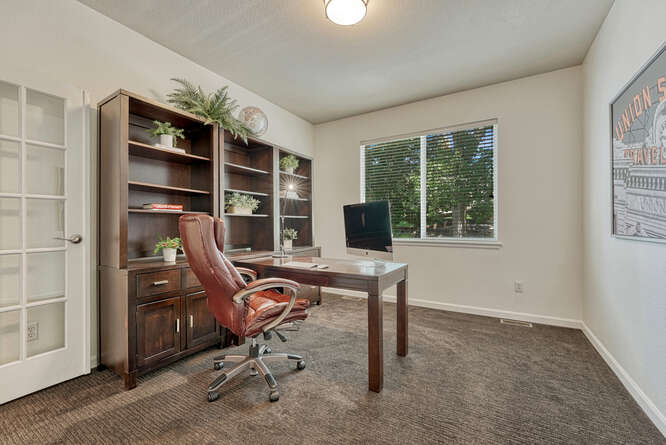 office with double sided desk and built-in bookshelves