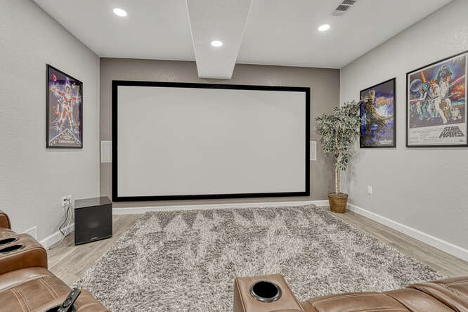 oversized built-in movie screen in basement entertainment area
