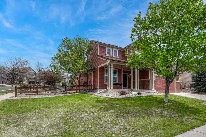 front elevation home with large side yard and porchswing