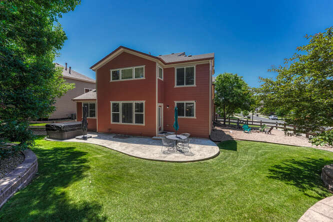 large back yard in parker co with flagstone patio and hot tub