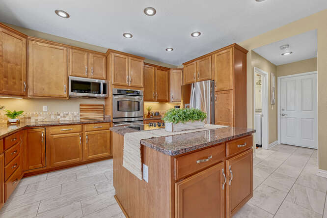 large kitchen with stainless steel appliances and center island
