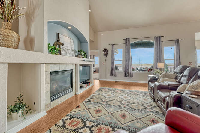 open floor plan with gas fireplace and niches