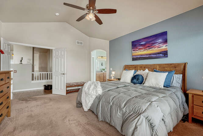 double doors into private primary bedroom with ensuite bath