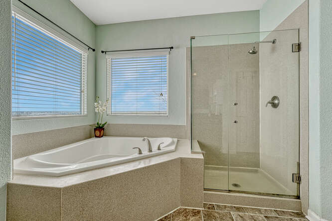 primary ensuite bath with frameless glass shower