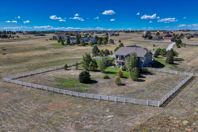 white perimeter fence on 5 acre property in parker colorado in deer creek farm estates