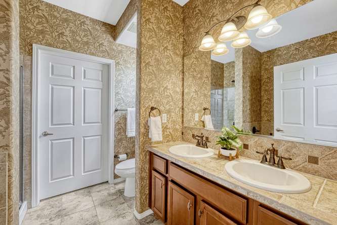 primary bath with wallpaper townhome englewood co