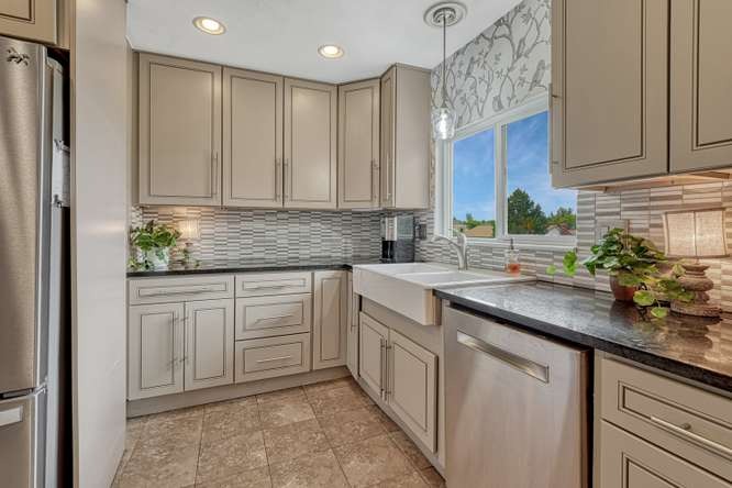 renovated kitchen gray cabinets bird wallpaper and large farm sink
