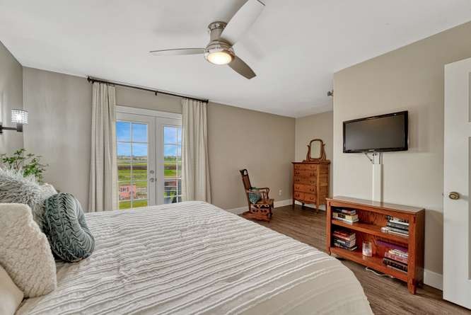 primary bedroom with private patio doors leading to deck