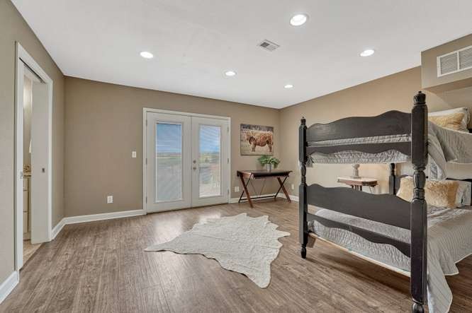 large bedroom with patio doors to outdoors