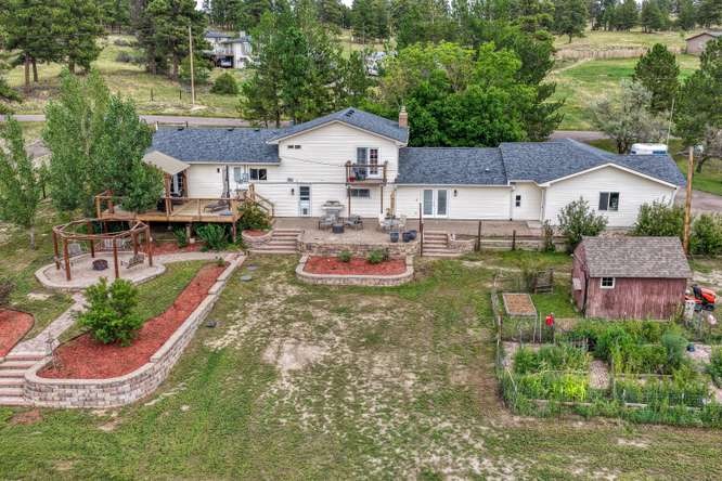 aerial back yard of home with ADU on acreage